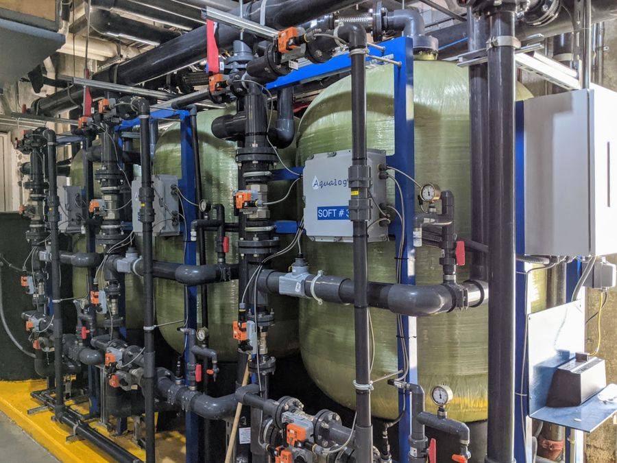 Multi-vessel utility water softener with automated valves